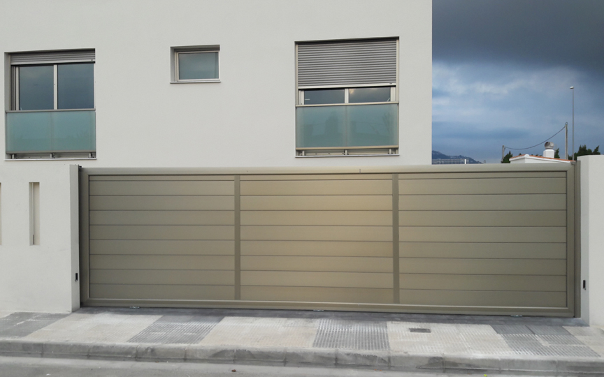 Puerta corredera de aluminio acabado color inoxidable de 6,5 metros de longitud